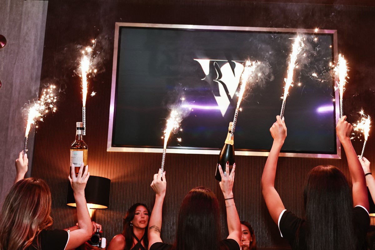 Bottles carried out under sparklers to the lit V on the big screen.